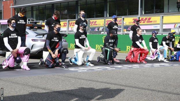 Drivers take the knee or stand during the anti-racism protest