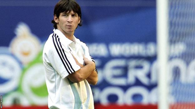 Lionel Messi stands, arms folded, in a training shirt at the 2006 World Cup in Germany