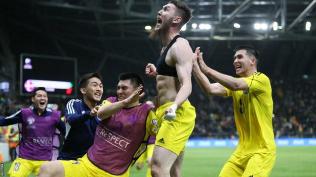 Abat Aimbetov celebrates scoring Kazakhstan's third goal against Denmark