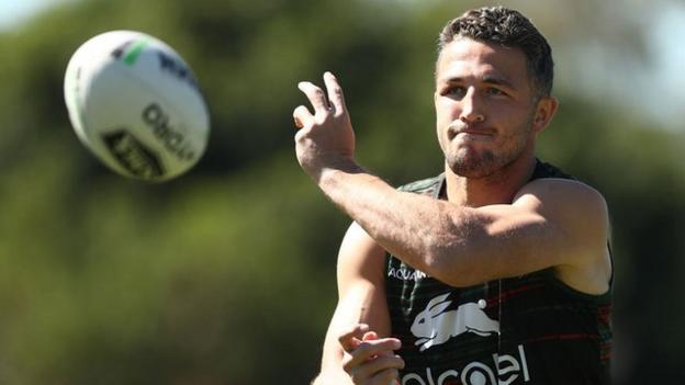 Sam Burgess throws a ball in training