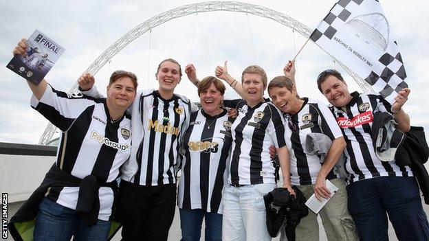 Notts County fans posing in front of Wembley Stadium