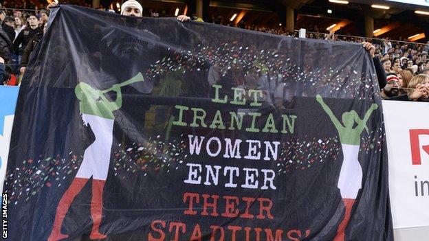 Supporters hold a banner during the friendly international football match between Sweden and Iran at the Friends Arena in Solna near Stockholm on March 31, 2015