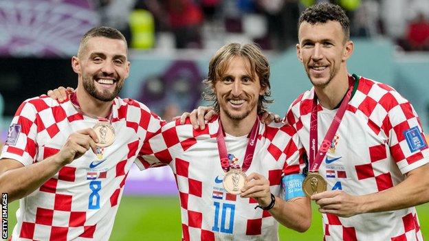 Luka Modric, centre, with his World Cup third-place medal