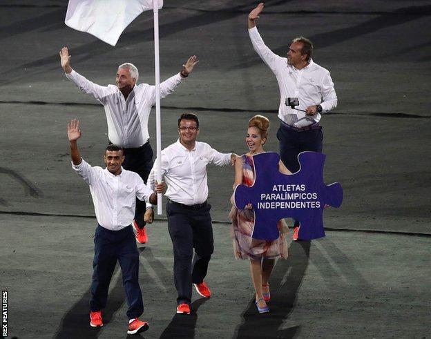 Ibrahim Al Hussein carries the flag of the first 'Independent Paralympic Team' at Rio 2016