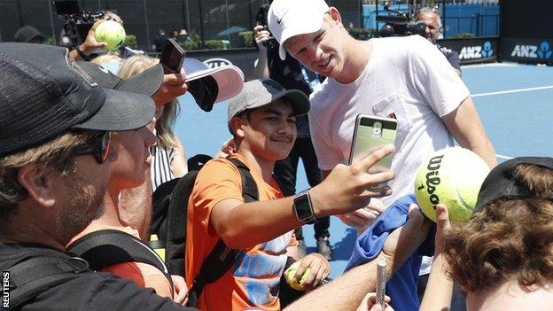 Kyle Edmund poses for a selfie while practising at the Australian Open