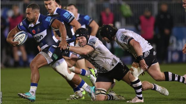 Ollie Lawrence (left) breaks with the ball for Bath