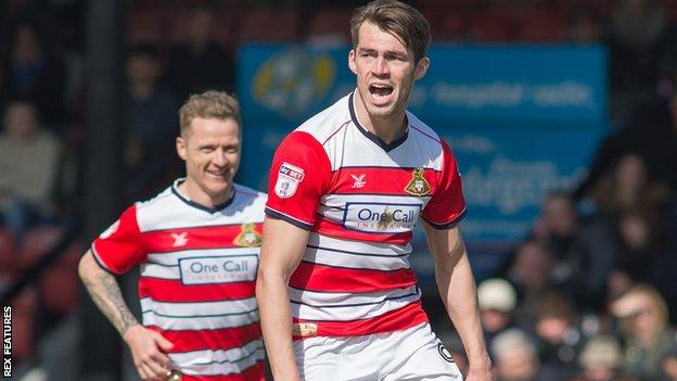 John Marquis heads in Doncaster's second goal against Grimsby