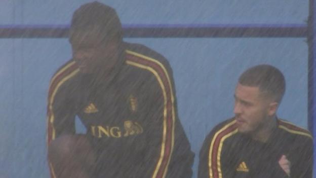 World Cup 2018: Belgium's Eden Hazard and Dedrick Boyata hide from sprinkler - BBC Sport