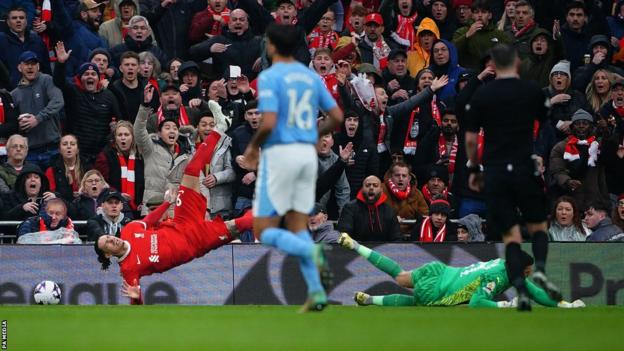 Darwin Nunes is brought down by Manchester City goalkeeper Ederson for Liverpool's penalty.