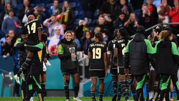 Jamaica players celebrate their draw with France