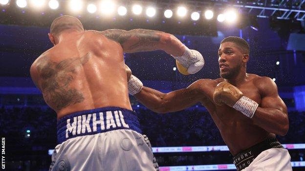 Anthony Joshua punches Oleksandr Usyk