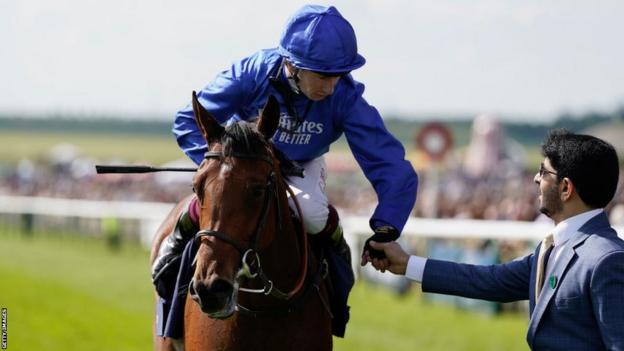 Oisin Murphy celebrates with trainer Saeed bin Suroor after riding Mawj to win the 1,000 Guineas at Newmarket