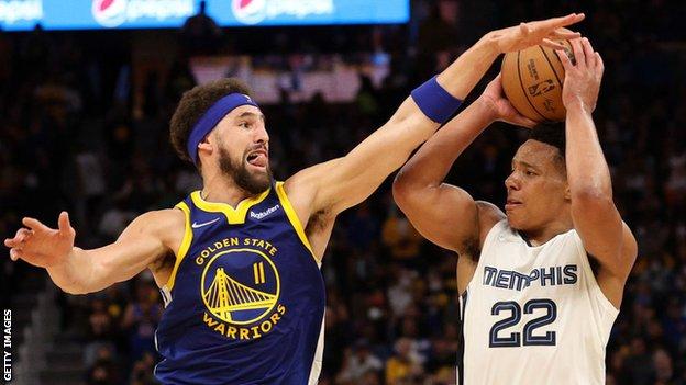 Desmond Bane of the Memphis Grizzlies controls the ball against Klay Thompson of the Golden State Warriors during game six of the 2022 NBA Playoffs Western Conference semi-finals