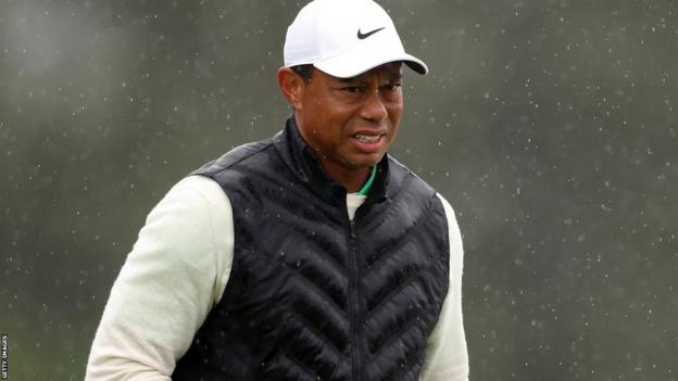 Tiger Woods looking uncomfortable successful  the rainfall  during his 3rd  circular  astatine  the 2023 Masters