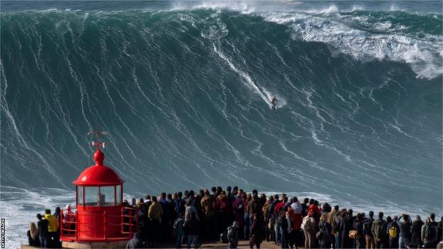 Rodrigo Koxa riding a wave in Nazare