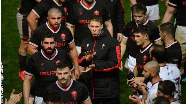 Liam Williams claps his Wales team-mates after they beat Georgia, sporting his mouth injury