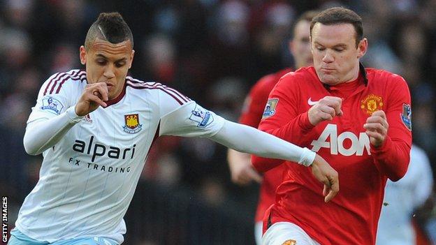 Ravel Morrison of West Ham United competes with Wayne Rooney of Manchester United in 2013