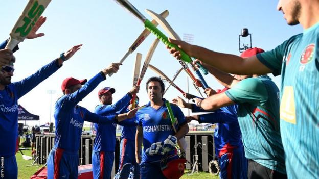 Afghanistan players make a tunnel from their bats for Afghan Asghar