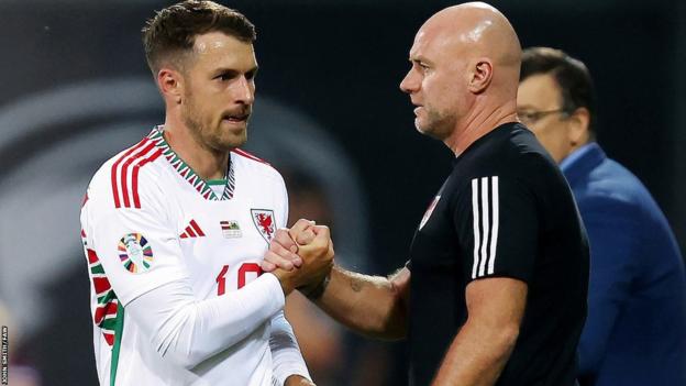 Wales' Aaron Ramsey shakes manager Robert Page's hand as he leaves the field