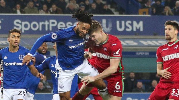 Ashley Williams and Alfie Mawson battle for the ball
