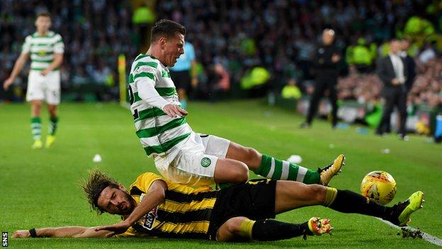 Marios Oikonomou tackles Callum McGregor during AEK Athens' 1-1 draw with Celtic