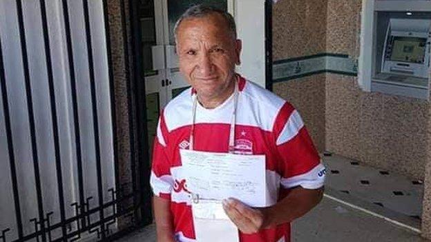 A Club Africain fan after donating to the team