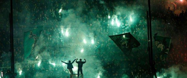 Panathinaikos fans light flares at the Apostolos Nikolaidis Stadium