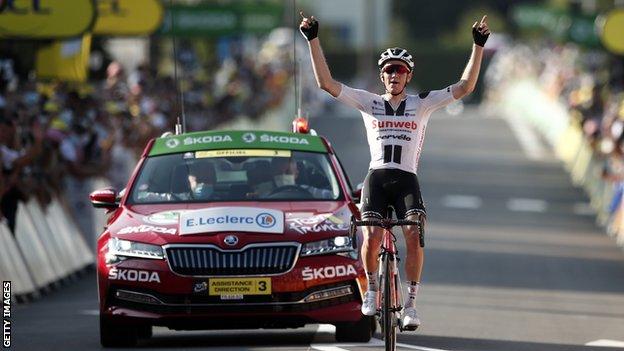 Sunweb's Soren Kragh Andersen raises his arms in celebration after winning stage 19 of the 2020 Tour de France