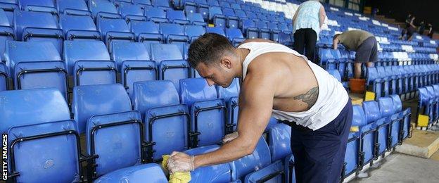 Bury fans clean seats