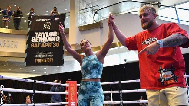 Amanda Serrano has her hand raised by Jake Paul