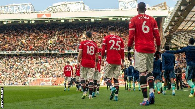 Manchester United players walk on to the pitch at Old Trafford