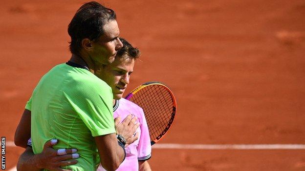 Rafaekl Nadal and Diego Schwartzman hug at the net