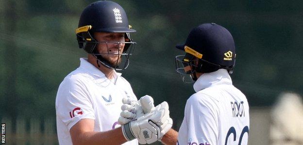 Ollie Robinson celebrates his 50 with Joe Root