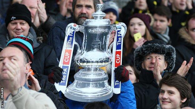 Fan holds cut-out of FA Cup
