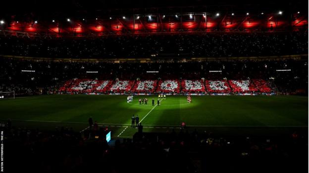 A Tifo spelt out 'Sir Bobby' during the minute's applause before the game