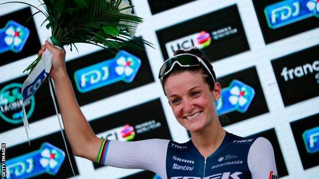 Britain's Lizzie Deignan holds up a bouquet of flowers on the podium after winning the 2020 La Course