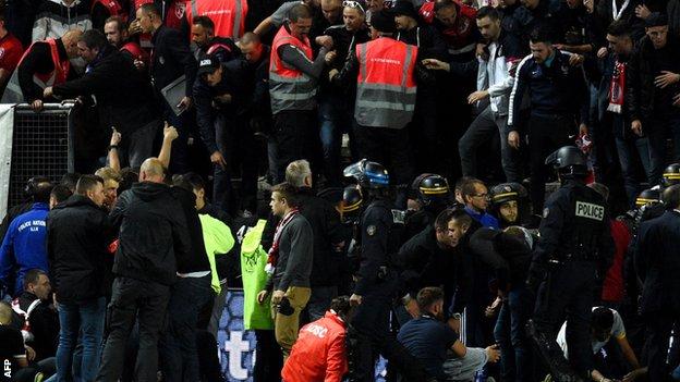 Police and stadium staff help the injured supporters