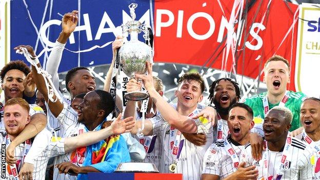Fulham players celebrate winning the Championship title