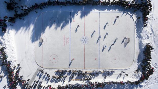  Players of the Ordynskoye district ice hockey team and HC Sibir Novosibirsk take part in a friendly on the frozen Orda River in Russia's Novosibirsk region