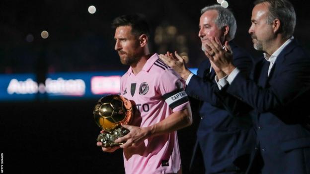 Lionel Messi holds the Ballon d'Or trophy at Inter Miami