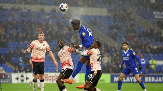 Sory Kaba rises high to win a header for Cardiff City