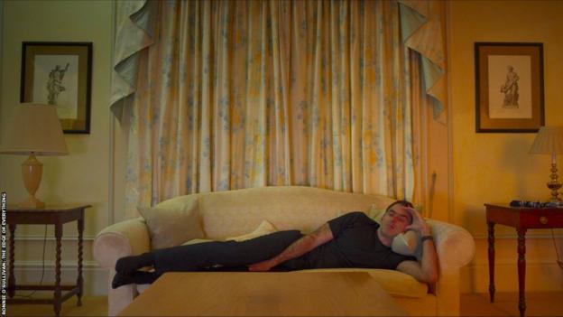 Ronnie O'Sullivan laying on couch.