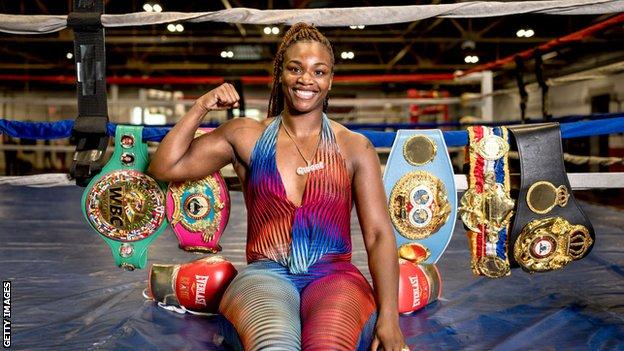 Claressa Shields poses with all her belts