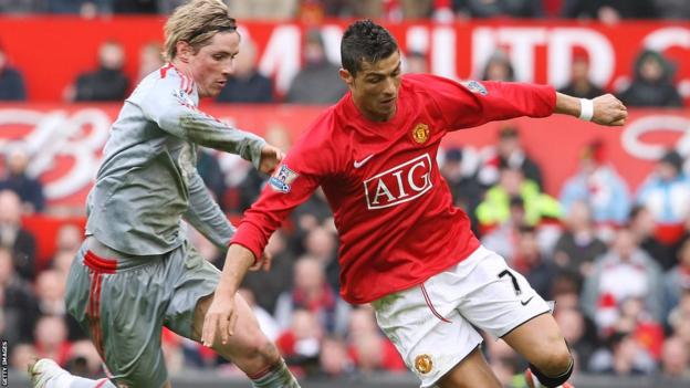 Cristiano Ronaldo and Fernando Torres compete for the ball