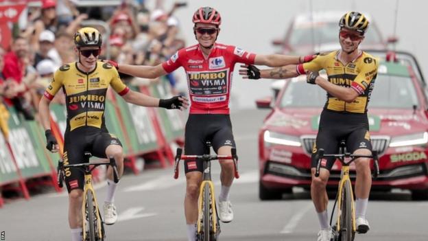 Jonas Vingegaard and Primoz Roglic cross the line with team-mate and race leader Sepp Kuss on the penultimate stage of the 2023 Vuelta a Espana