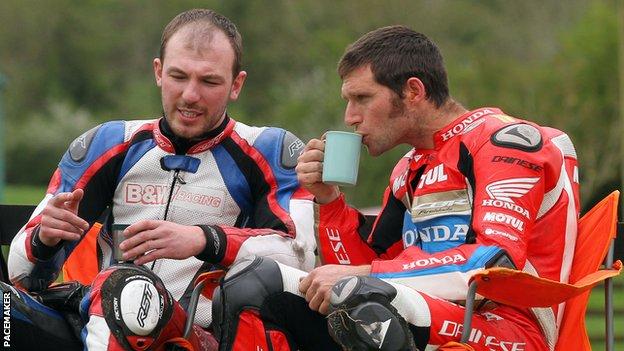 Guy Martin sips a cup of tea after crashing out of the opening superbike race at the Tandragee 100