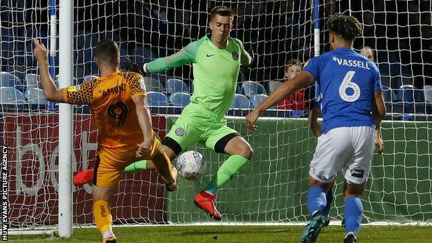 Padraig Amond of Newport County puts the ball past goalkeeper Owen Evans of Macclesfield Town