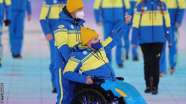 A member of the Ukrainian team raises his fist