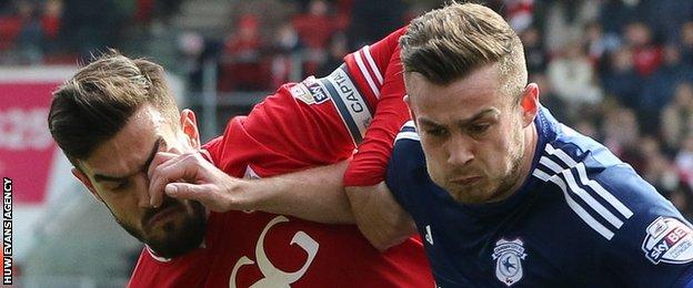 Joe Ralls of Cardiff City holds off Bristol City's Marlon Pack