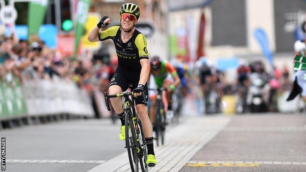 Australia's Cameron Meyer raises his hand to celebrate victory on stage two of the 2018 Tour of Britain